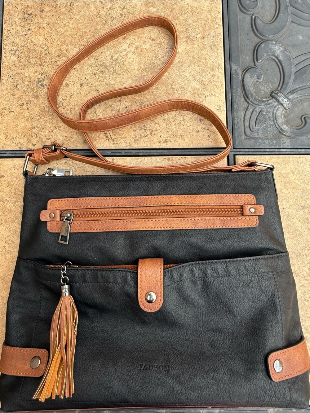 Faux Leather Black and Tan Crossbody Bag with Tassel Accent